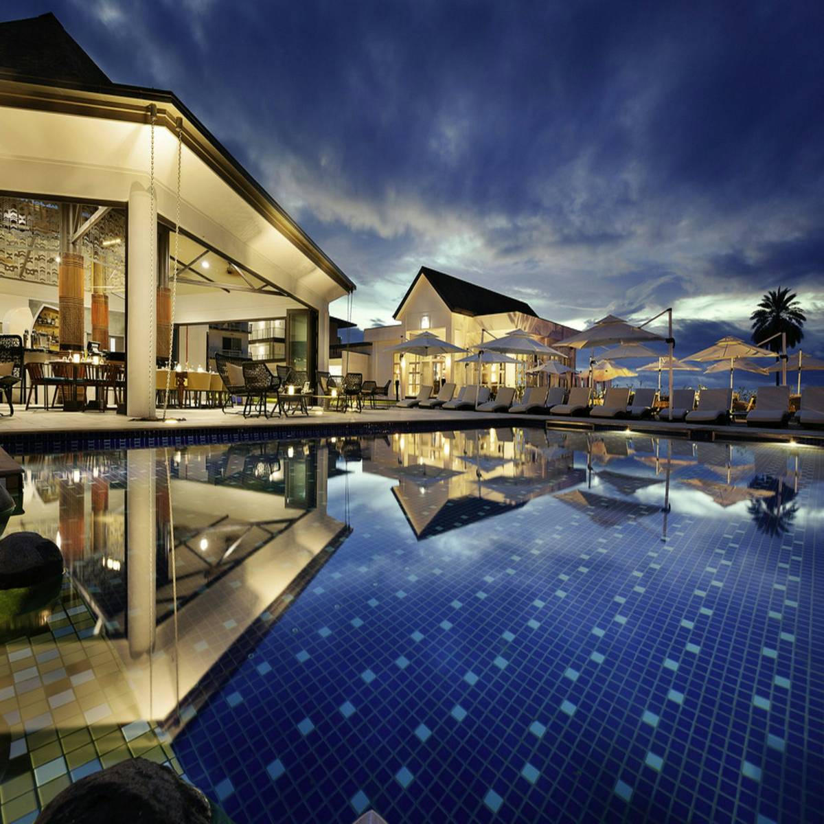 A resort pool reflecting the evening sky